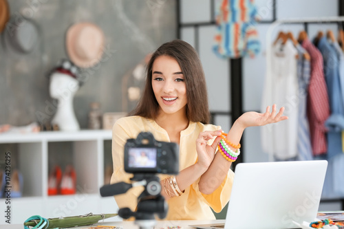 Young female blogger with a...