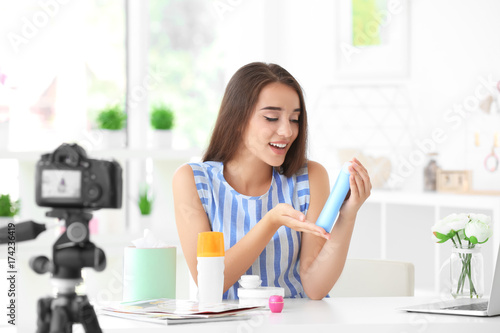 Young female blogger with c...