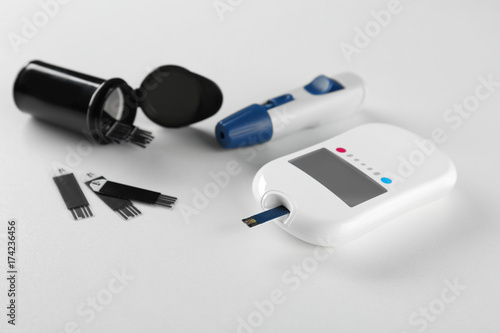 Composition with digital glucometer on white background. Diabetes concept