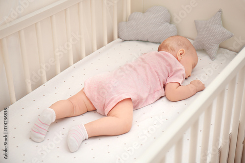 Baby sleeping in crib at home