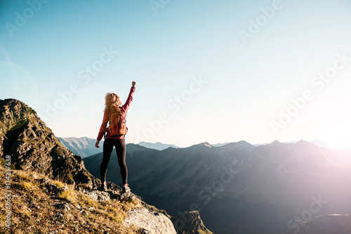 Young woman on the top in the mountains