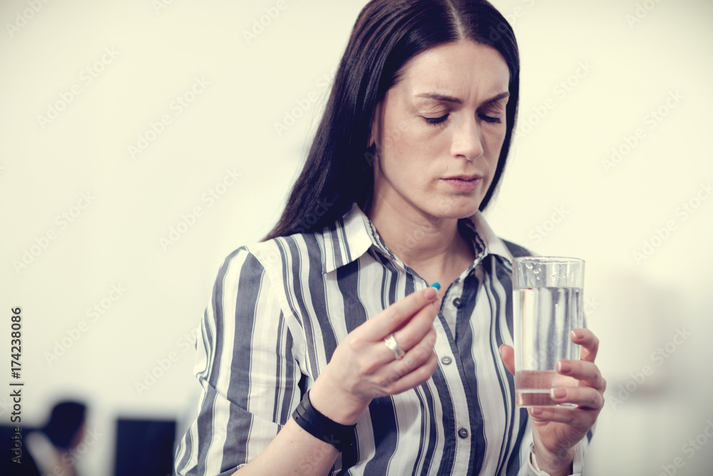 Sad unhappy woman holding a glass of water Sad unhappy woman holding a glass of water