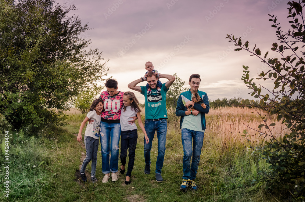 Happy young family spending time together outside in green nature.