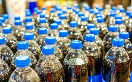 many pepsi bottles stand in strong rows photo