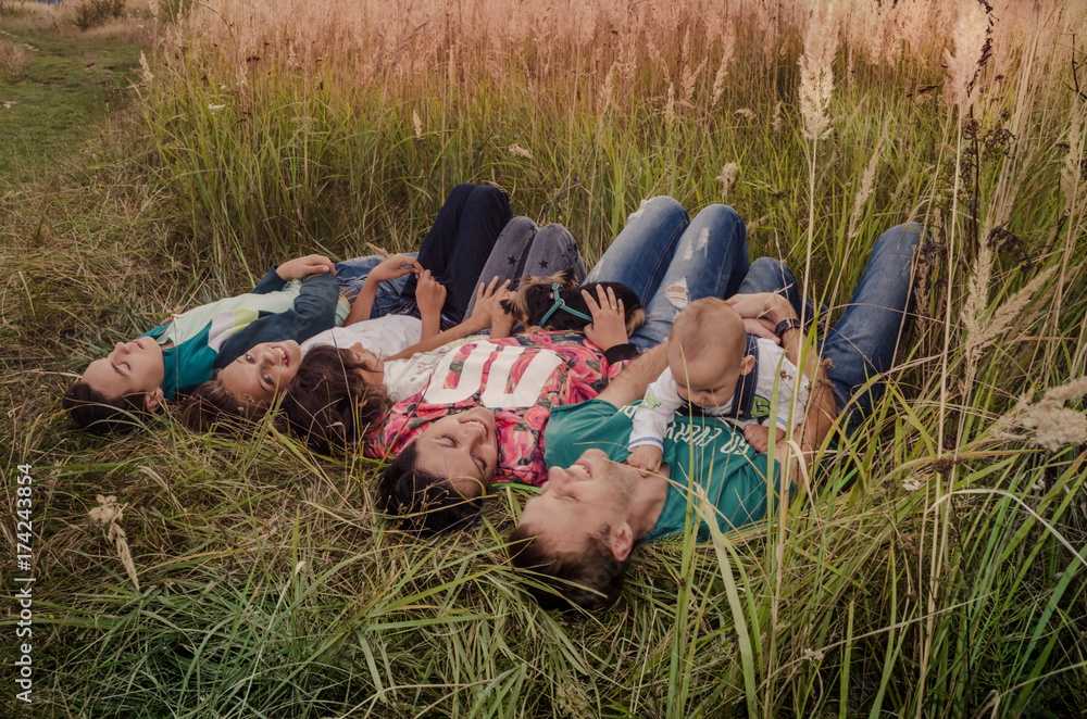 Happy young family spending time together outside in green nature.