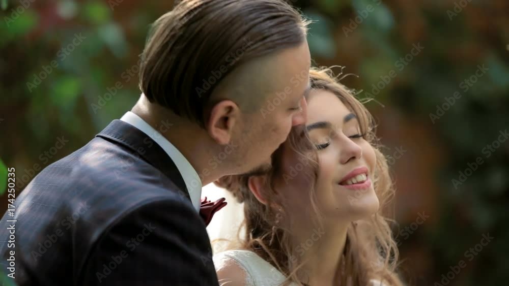 Portrait of newlywed couple in love in park. Beautiful bride and groom in park. tenderness love Portrait of newlywed couple in love in park. Beautiful bride and groom in park. tenderness love