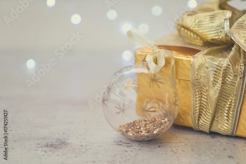 Christmas golden present box with christmas ball close up  retro toned