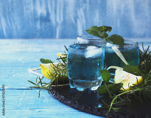 Blue curacao liqueur or sambuca with lemon