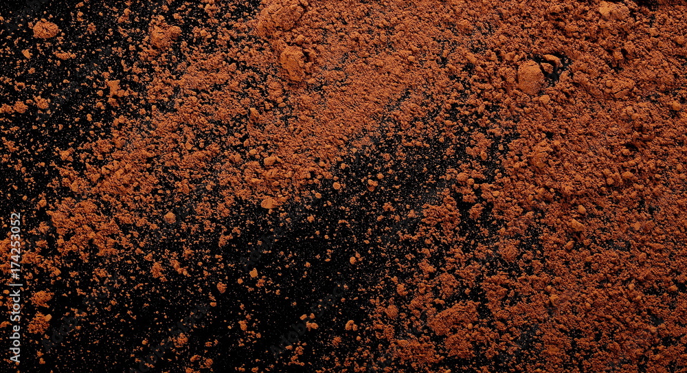 pile cocoa powder isolated on black background