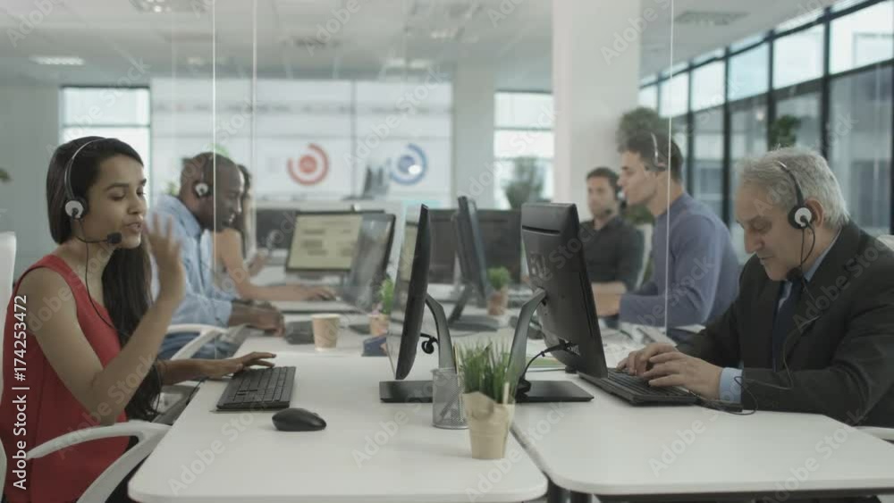 Friendly financial advice team taking calls in busy call center Friendly financial advice team taking calls in busy call center