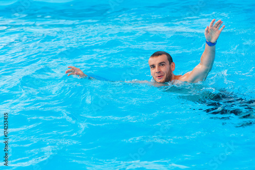 Man swimming in pool outdoor on summer resort © lisovoy