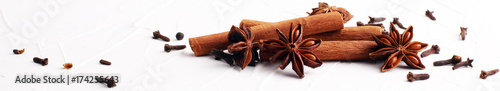 cinnamon, staranise and cloves. winter spices on white background photo