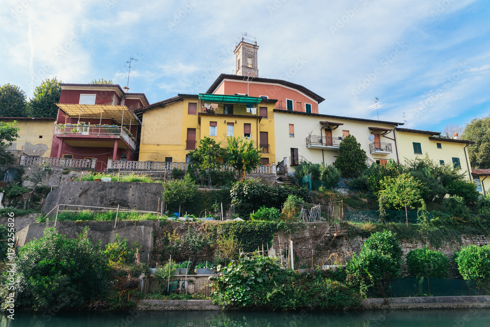 Colourful hillside buildings in Italy with vegetable gardens Colourful hillside buildings in Italy with vegetable gardens