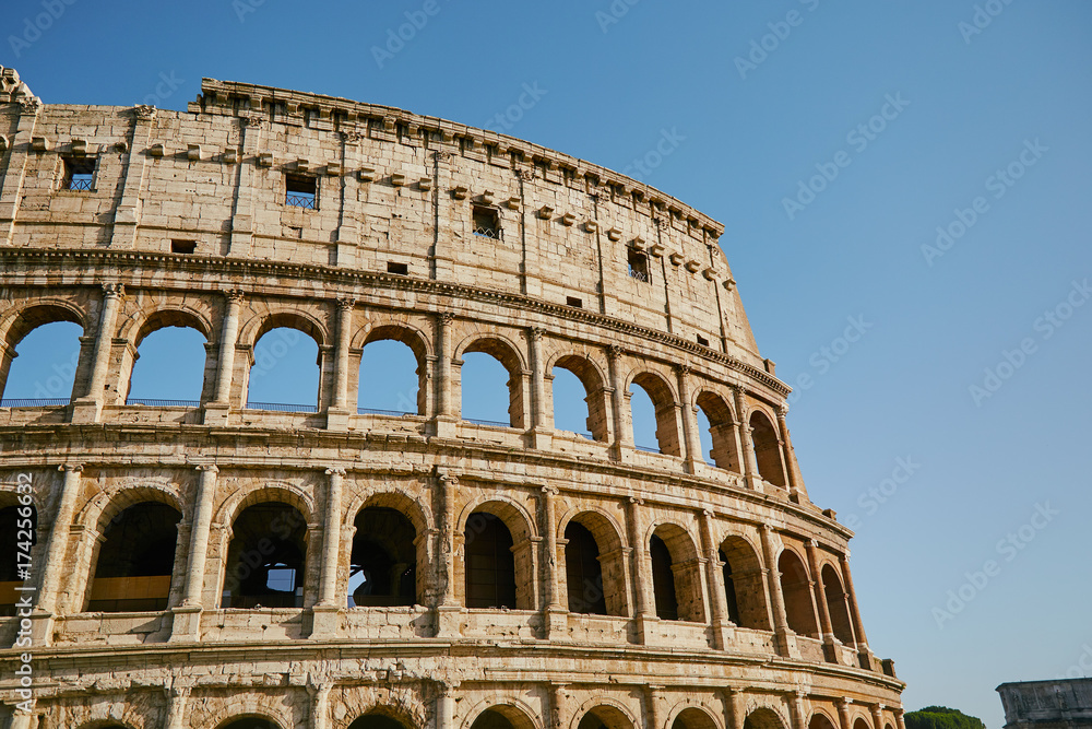 Part of the Coliseum against the blue sky Rome, Italy