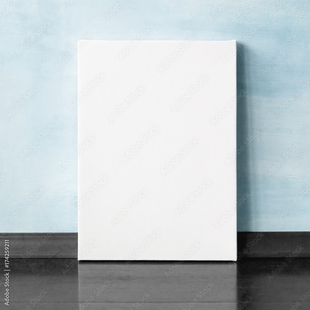 Mock-up poster in the interior. Blank vertical canvas. Blue wall on background. Mock-up poster in the interior. Blank vertical canvas. Blue wall on background.