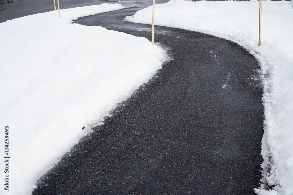 Fototapeta premium winding sidewalk after snow with snow removed