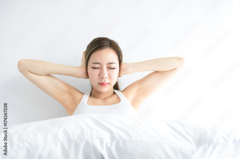 Asian beauty woman feel annoy alarm clock in white bedroom after wake up Asian beauty woman feel annoy alarm clock in white bedroom after wake up