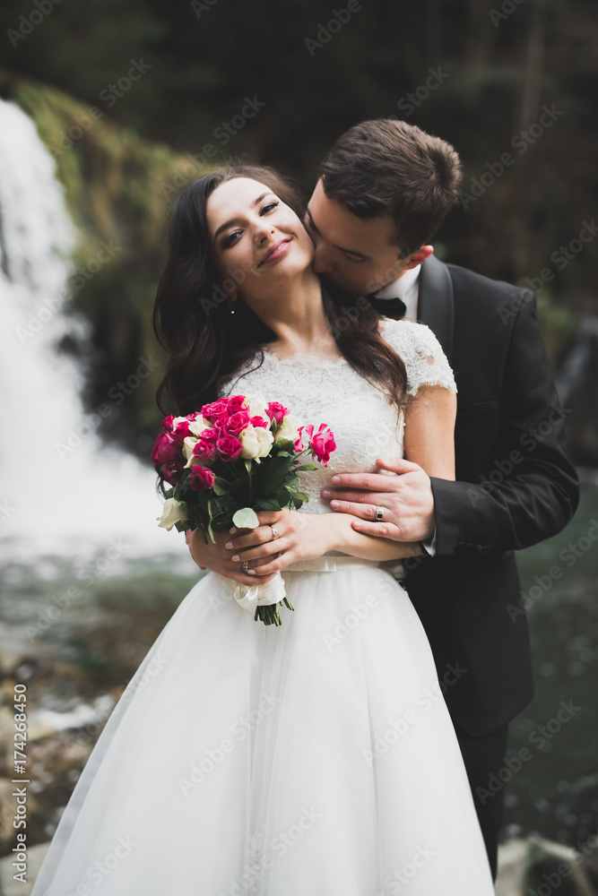 Wedding couple, groom and bride hugging, outdoor near river Wedding couple, groom and bride hugging, outdoor near river