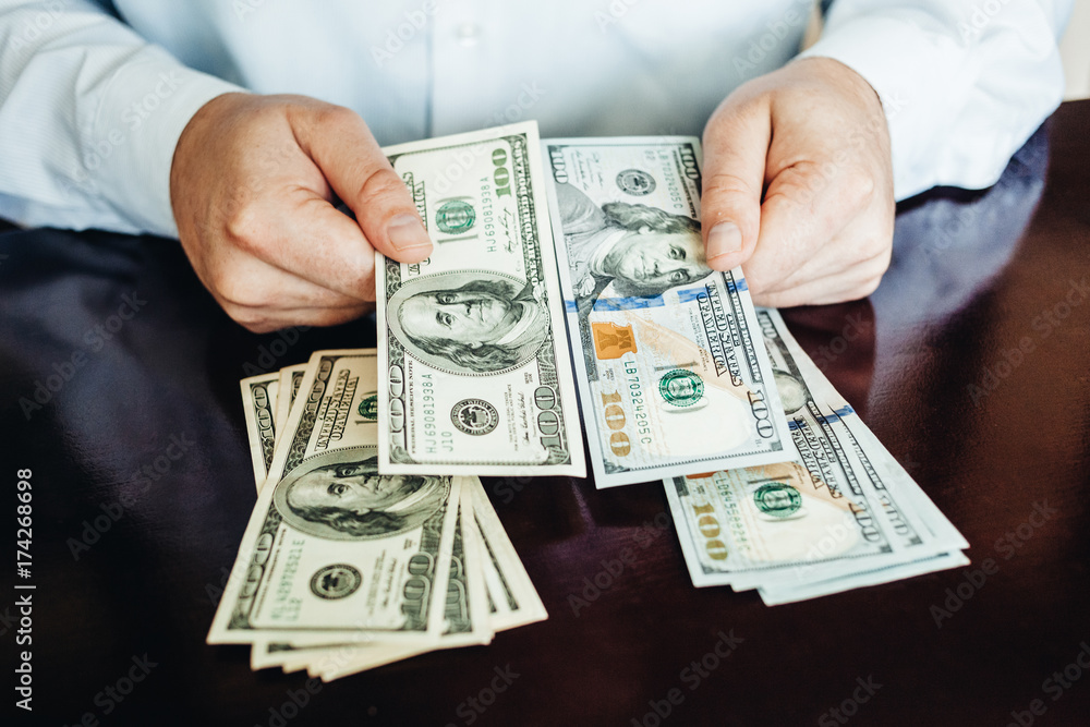 hundred dollar bills on a wooden background hundred dollar bills on a wooden background