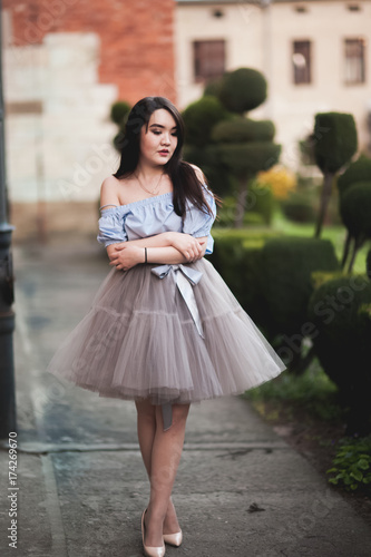 Young Asians girl with modern dress posing in an old Krakow