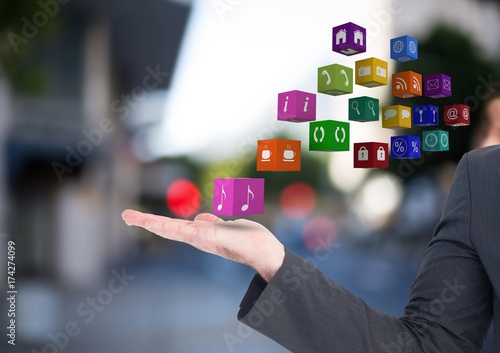 hands with application icons in the street (blurred)