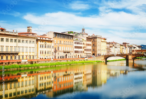 old town and river Arno reflecting in water at summer day, Florence, Italy, retro toned