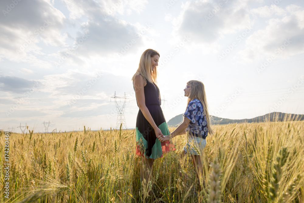 Pretty young mother with cute little daughter are happy in sunny day Pretty young mother with cute little daughter are happy in sunny day