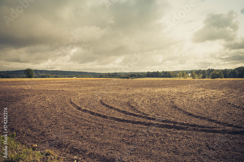 Arable land by the lake  Finland  tonning.Autumn view