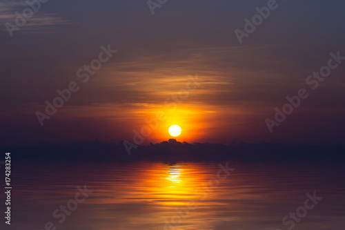 Fototapeta Naklejka Na Ścianę i Meble -  Sunrise on the sky and dark cloud at the lake.