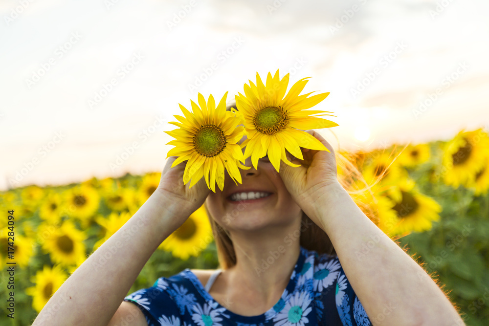 happy girl on a field of sunflowers on summer sunset happy girl on a field of sunflowers on summer sunset