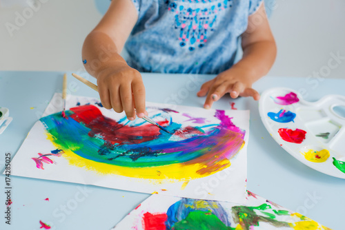 Brush with paint in the child's hand