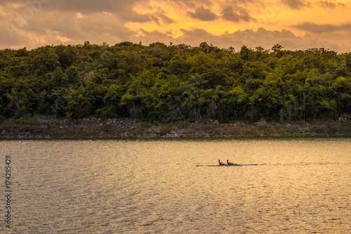 Sculling under sunset sky