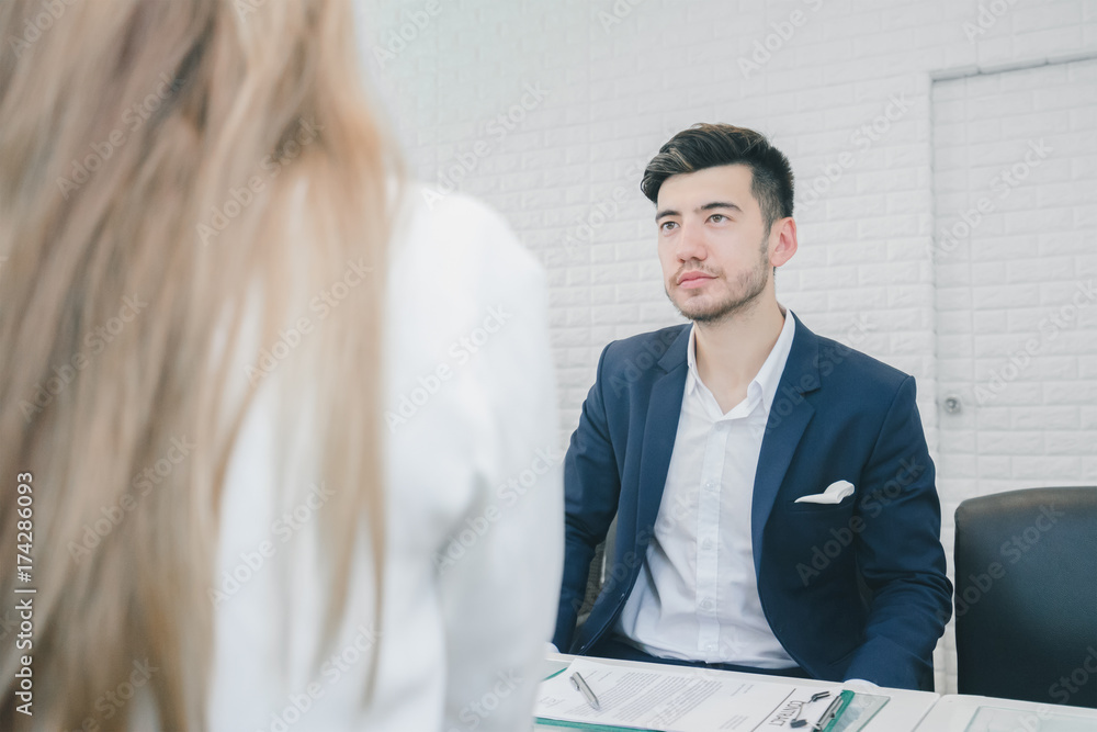 Professional businessman and businesswoman discussing together in the office Professional businessman and businesswoman discussing together in the office