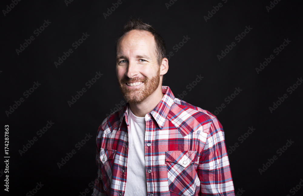 Portrait of a young successful man over black background