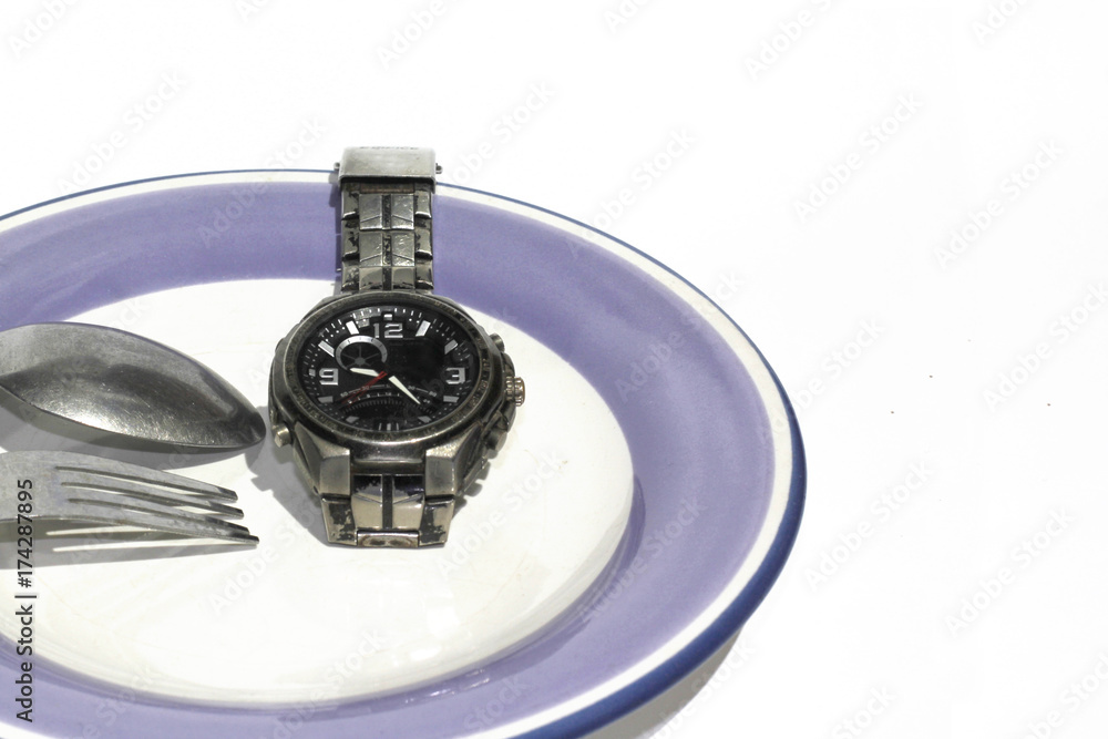 weight loss or diet concept stock image of watch on plate.Time eating concept