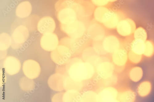 Yellow Festive Christmas Bokeh lights with soft effect. Glowing lights for Xmas Holiday greeting card and your design. Defocused Christmas decorations..
