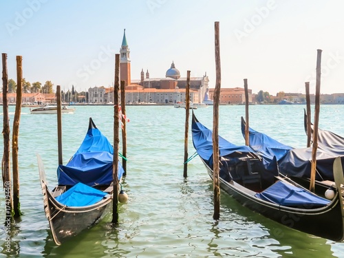 Gondolas moored in the Venetian lagoon. Venice, Italy