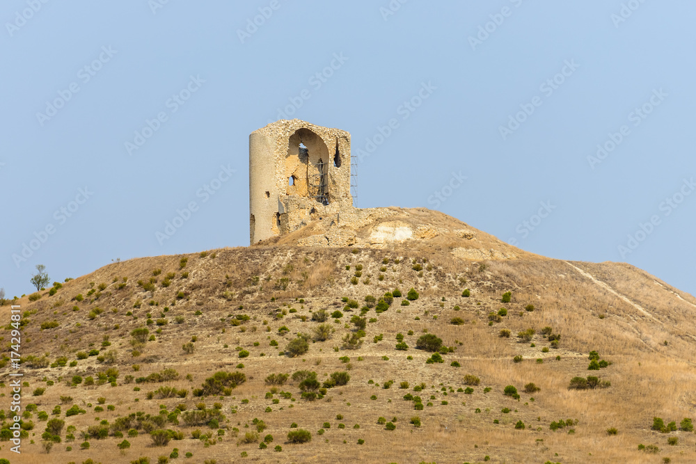 ruins of an ancient tower on a hill