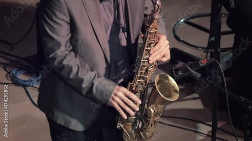 Playing the saxophone.