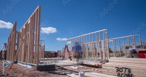 Workers Framing a New Home Construction Time-lapse. a time-lapse of contract workers putting together the frame to a new home construction during the daytime
