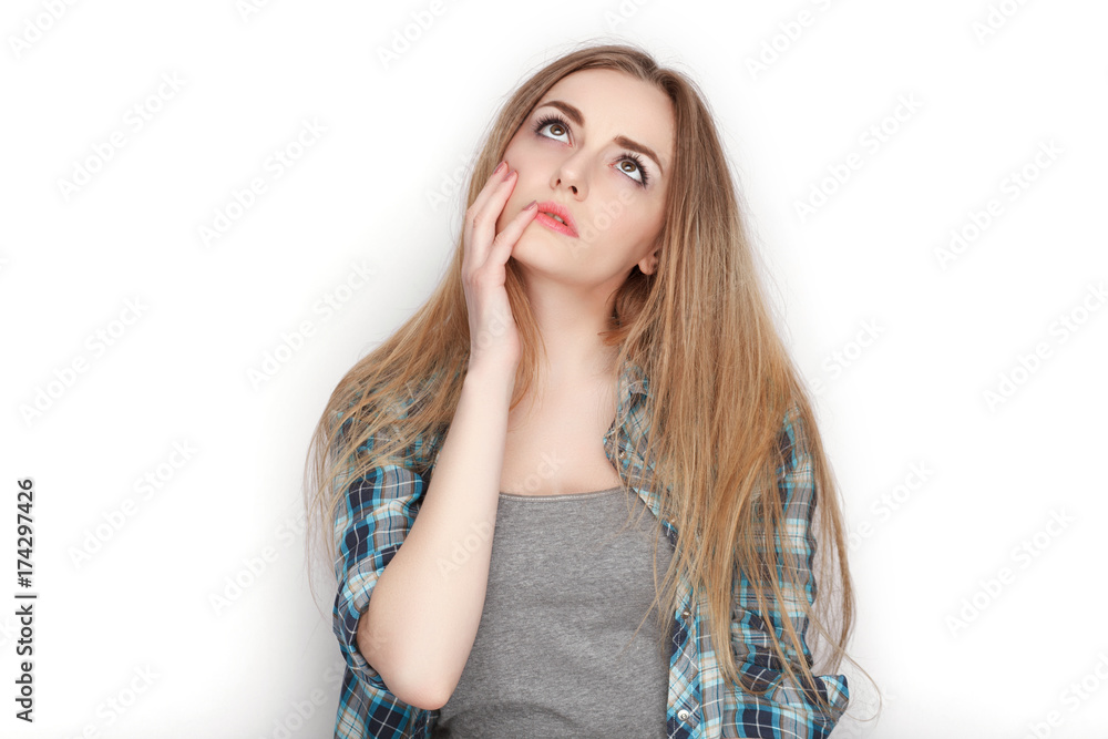 Beauty portrait of young adorable fresh looking blonde woman in blue plaid shirt. Emotion and facial expression concept.