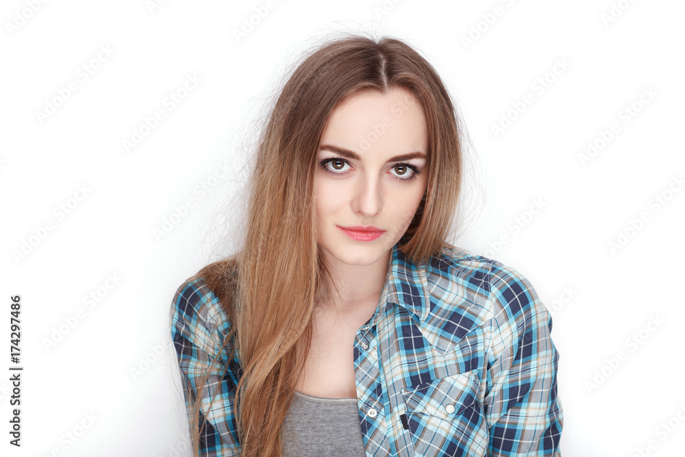 Beauty portrait of young adorable fresh looking blonde woman in blue plaid shirt. Emotion and facial expression concept. Beauty portrait of young adorable fresh looking blonde woman in blue plaid shirt. Emotion and facial expression concept.