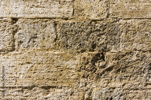 Texture of wall in italian tuscany town from tuf stone photo