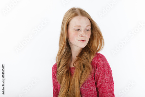 Beauty portrait of young adorable fresh looking redhead woman with gorgeous extra long hair. Emotion and facial expression concept. © sergeyzapotylok