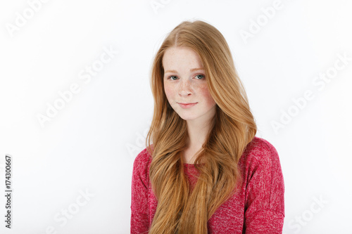 Beauty portrait of young adorable fresh looking redhead woman with gorgeous extra long hair. Emotion and facial expression concept. © sergeyzapotylok
