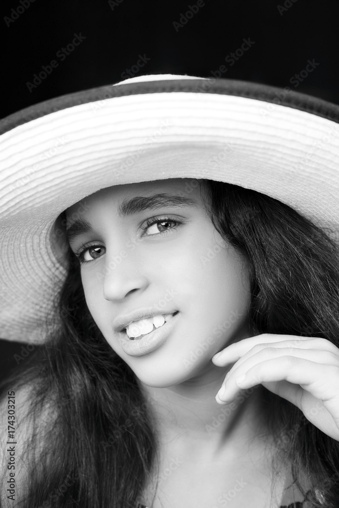 Portrait of a young african american girl laughing with sun hat Portrait of a young african american girl laughing with sun hat