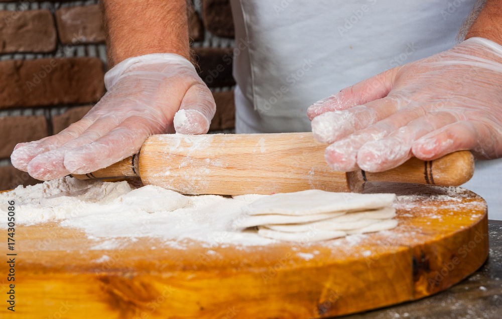 chef hands in process of making home-made dumplings, ravioli or pelmeni chef hands in process of making home-made dumplings, ravioli or pelmeni