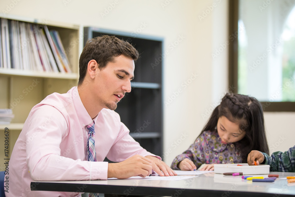 Portrait of Teacher teaching Children at classroom together, People with education concept.