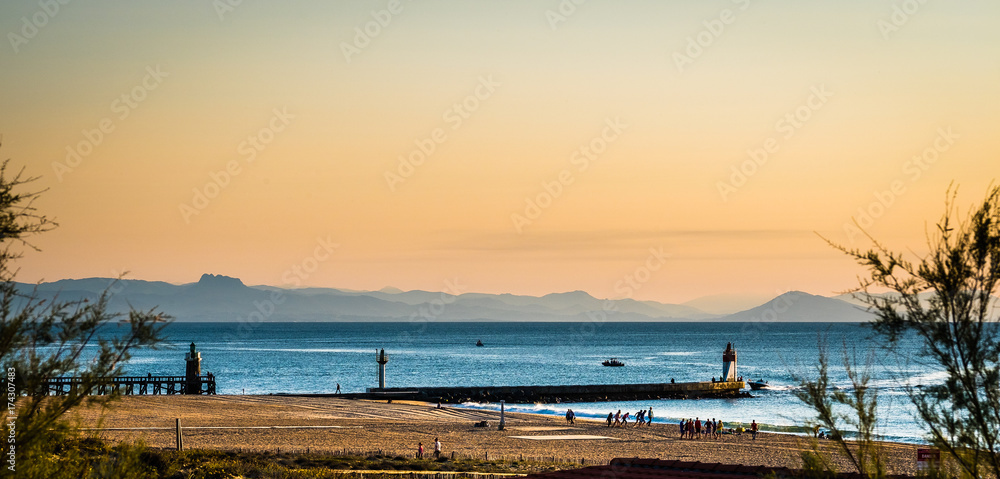 French basque sunset with beach, pier and mountains