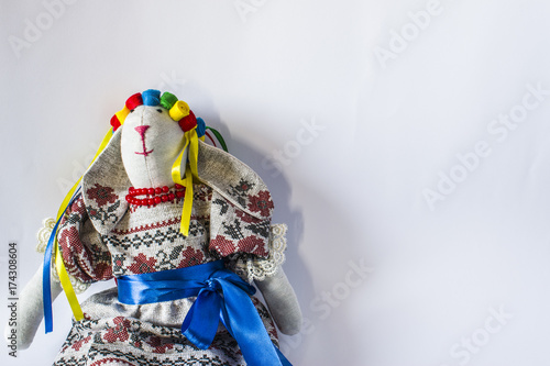 A doll in national Ukrainian in a suit with ribbons.